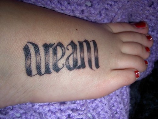 Black Ink Ambigram Dream Lettering Tattoo On Girl Foot