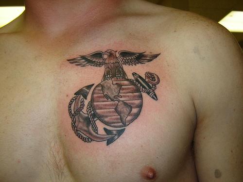 Black Ink Marine Logo Tattoo On Man Chest