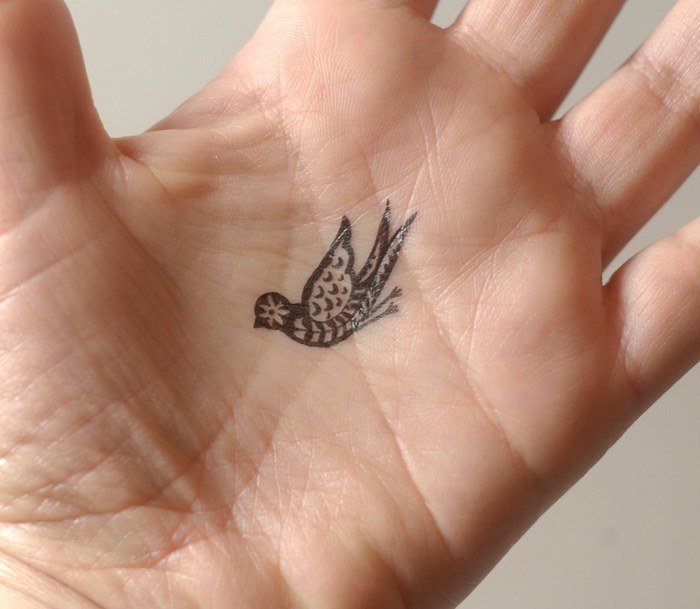 Black Little Paisley Bird Tattoo On Hand Palm