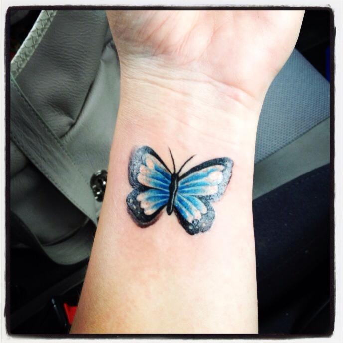 Black Outline Blue Butterfly Tattoo On Wrist
