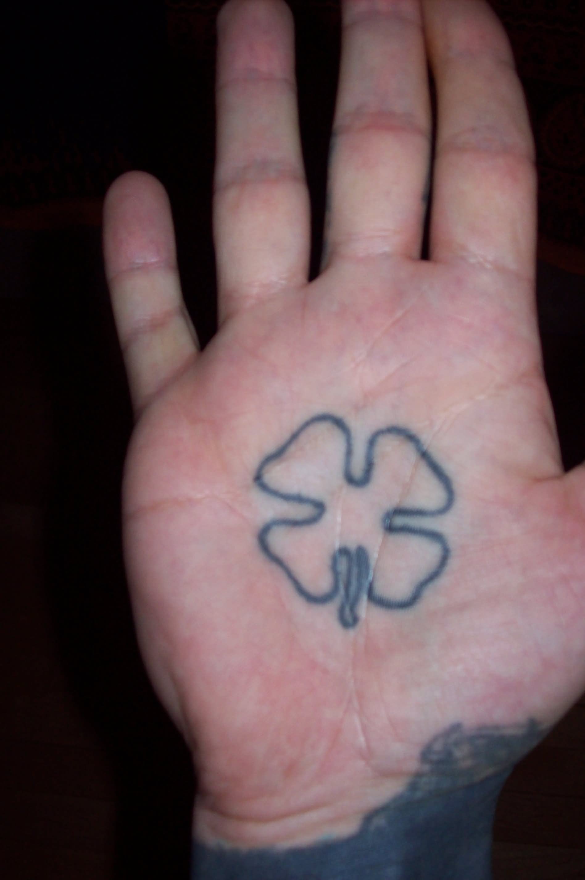 Black Outline Four Leaf Tattoo On Hand Palm