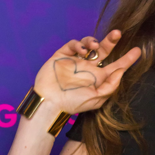 Black Outline Heart Tattoo On Girl Hand Palm