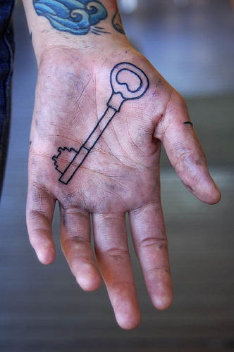 Black Outline Key Tattoo On Hand Palm