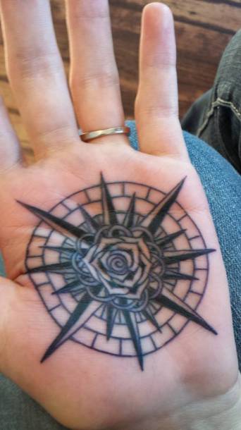 Black Rose In Compass Tattoo On Hand Palm