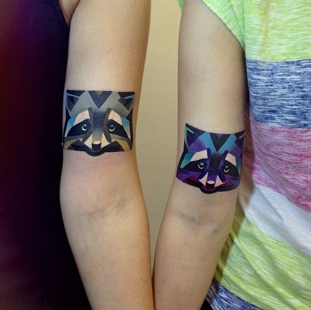 Colorful Geometric Raccoon Head Tattoo On Couple Bicep
