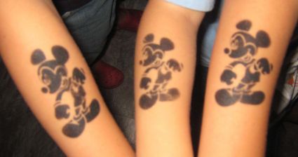 Silhouette Mickey Mouse Tattoo On Forearm