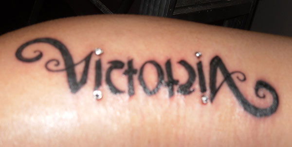 Victoria Ambigram Tattoo On Bicep