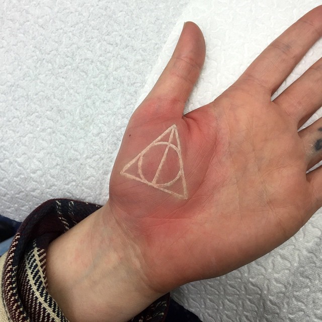 White Ink Deathly Hallow Tattoo On Hand Palm