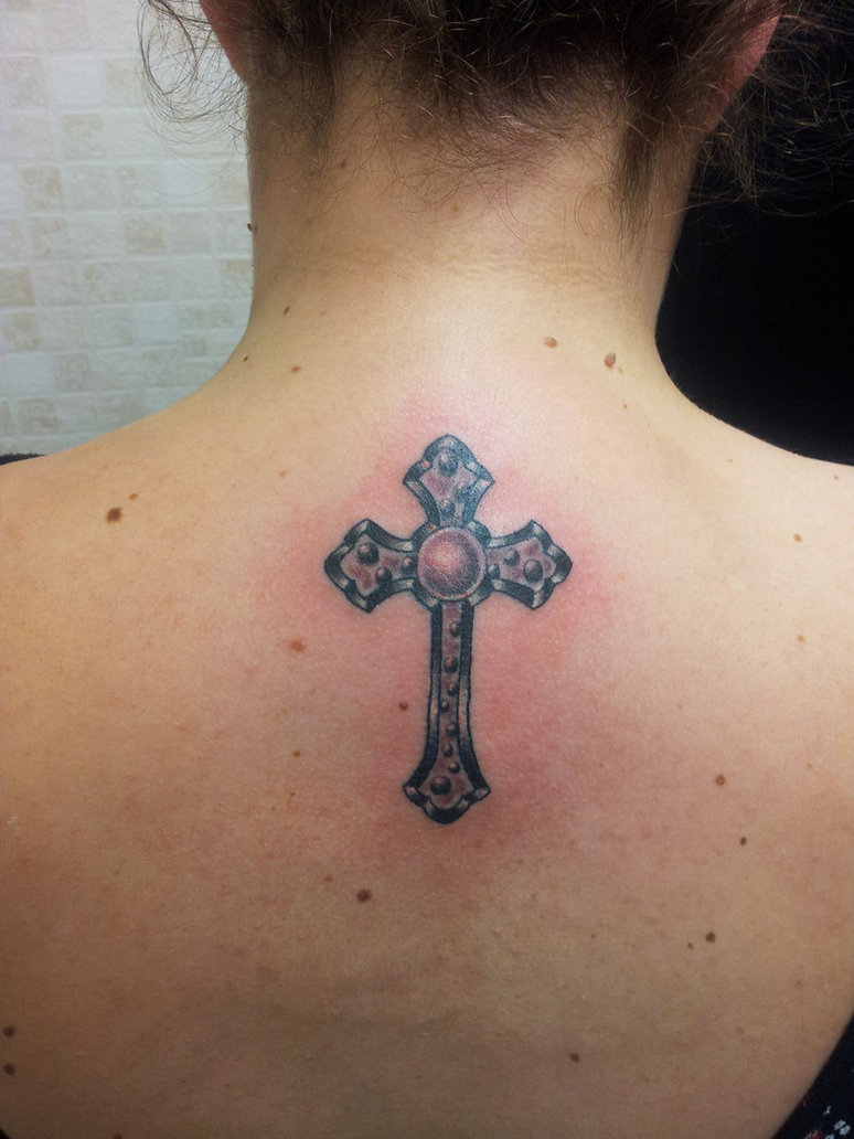 Amazing small cross tattoo on upper back
