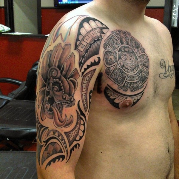 Black And Grey Aztec Sun Tattoo On Man Chest