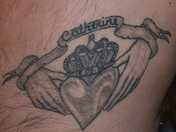 Black And Grey Claddagh With Banner Tattoo Design