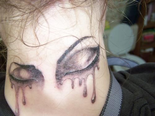 Black And Grey Crying Eyes Tattoo On Back Neck
