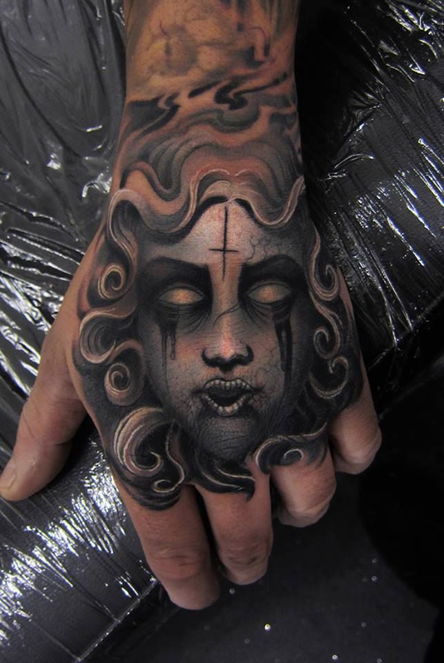 Black And Grey Medusa Face Tattoo On Left Hand