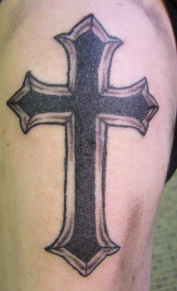 Black Christian cross tattoo on Shoulder