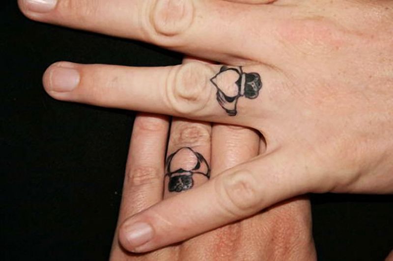 Black Claddagh Tattoo On Couple Finger