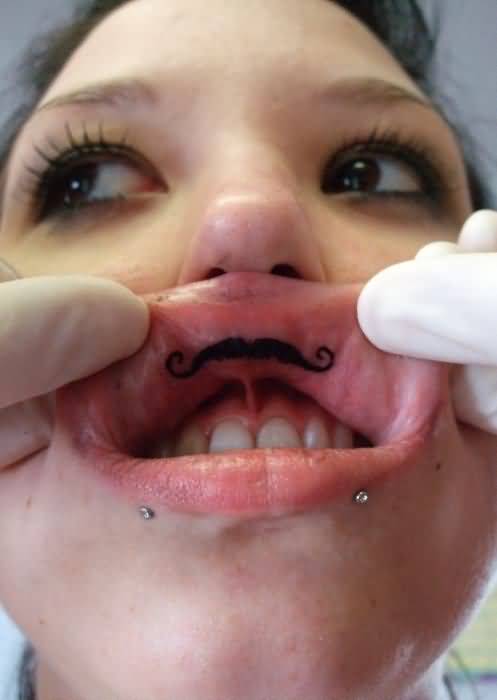 Black El Bandito Mustache Tattoo On Girl Inner Lip