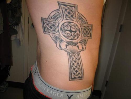 Black Ink Celtic Claddagh Tattoo On Man Side Rib