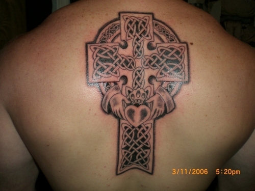 Black Ink Celtic Cross Claddagh Tattoo On Man Upper Back