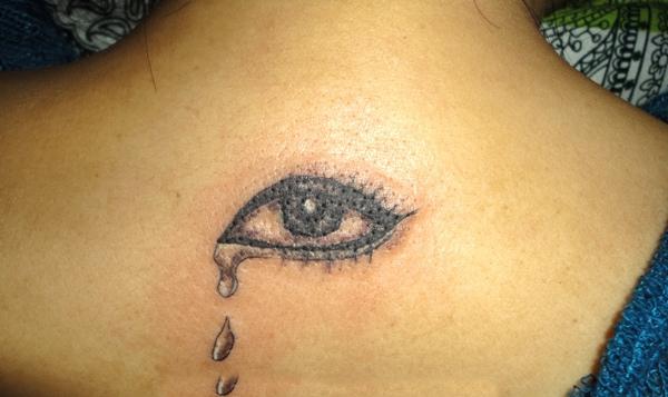 Black Ink Crying Eye Tattoo On Upper Back