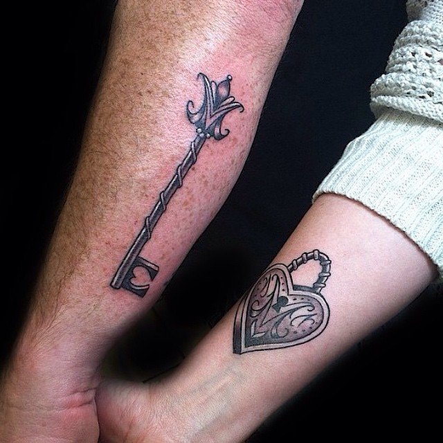 Black Ink Heart Shape Lock And Key Tattoo On Couple Forearm