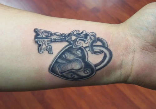 Black Ink Heart Shape Lock With Key Tattoo On Wrist