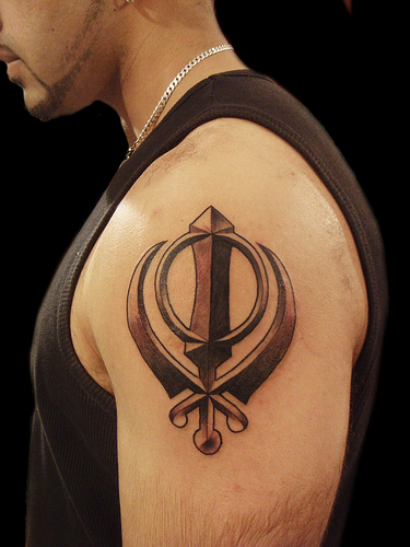 Black Ink Sikhism Khanda Tattoo On Man Left Shoulder