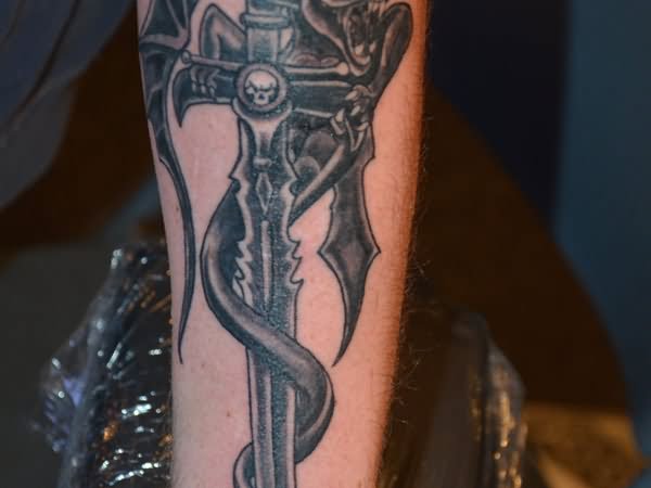 Black Ink Sword With Dragon Tattoo Design For Forearm