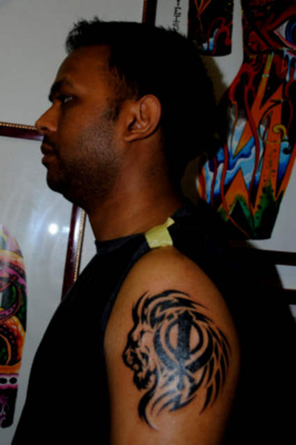 Black Sikhism Khanda With Tribal Lion Tattoo On Man Left Shoulder