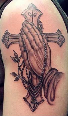 Black and grey cross with praying hands tattoo on half sleeve