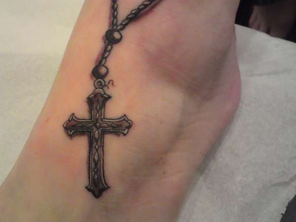 Black ink rosary cross tattoo on ankle