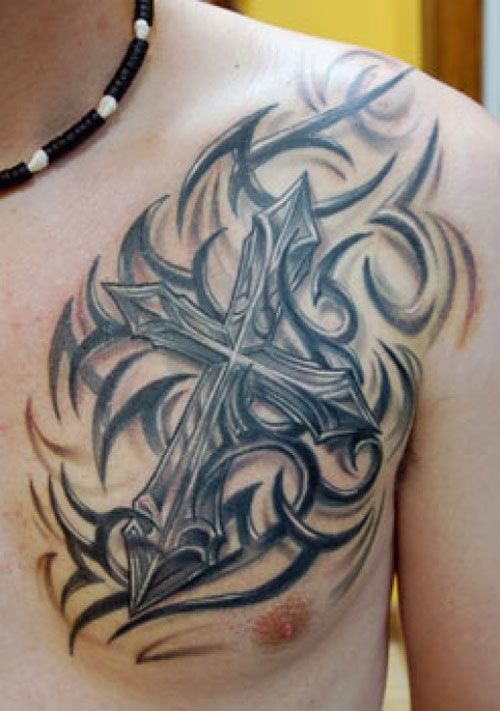 Black tribal cross tattoo on left chest