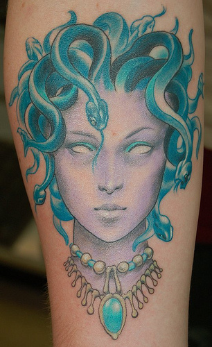Blue Ink Medusa Face Tattoo On Leg