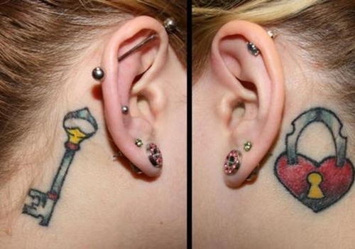 Colorful Heart Shape Lock And Key Tattoo On Girl Behind The Ear