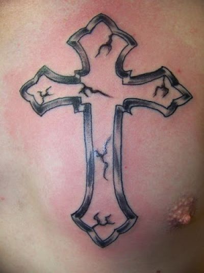 Grey cracked cross tattoo on chest
