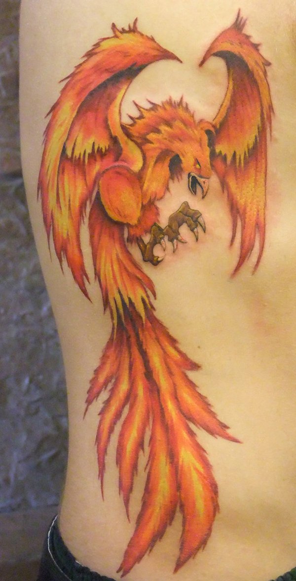 Orange Ink Flying Phoenix Tattoo On Side Rib