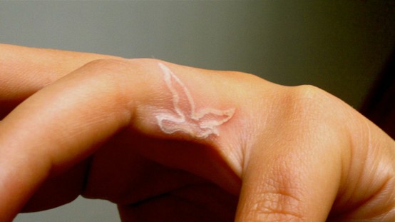 Outline White Ink Flying Bird Finger Tattoo