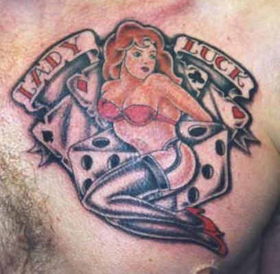 Pin Up Girl With Dice And Banner Tattoo On Man Chest
