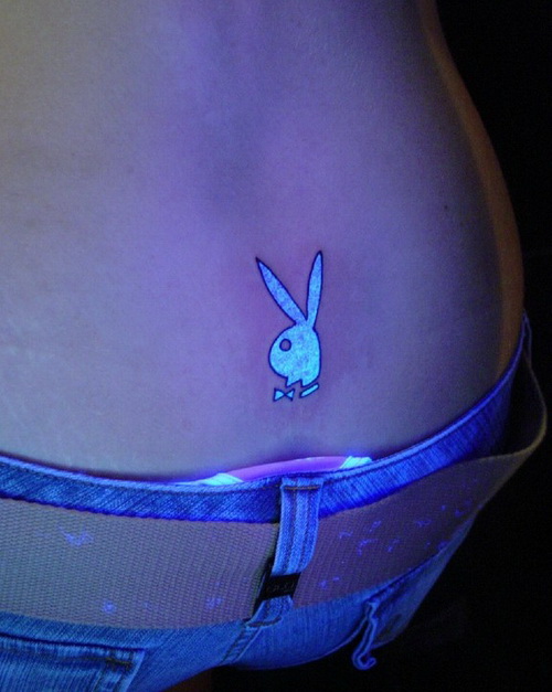 Playboy Bunny White Ink Tattoo On Lower Back Under Black Light