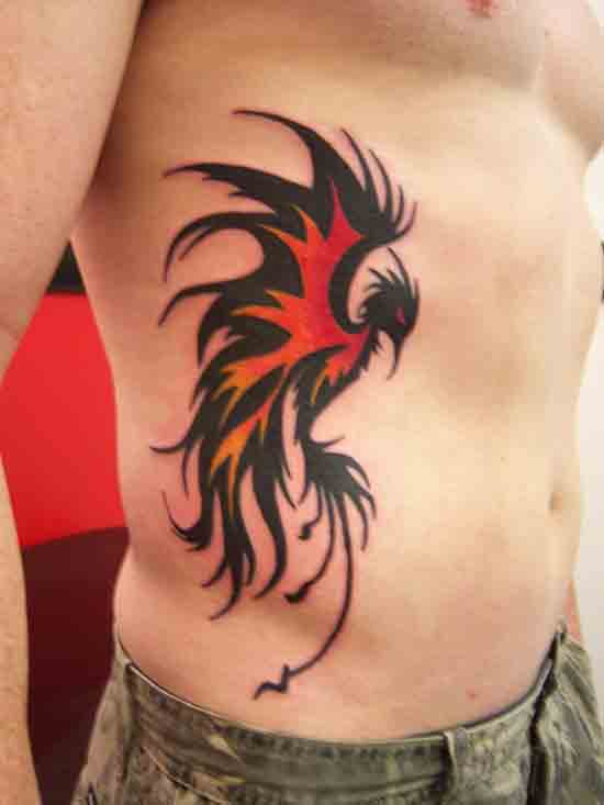 Red And Black Tribal Phoenix Tattoo On Man Side Rib