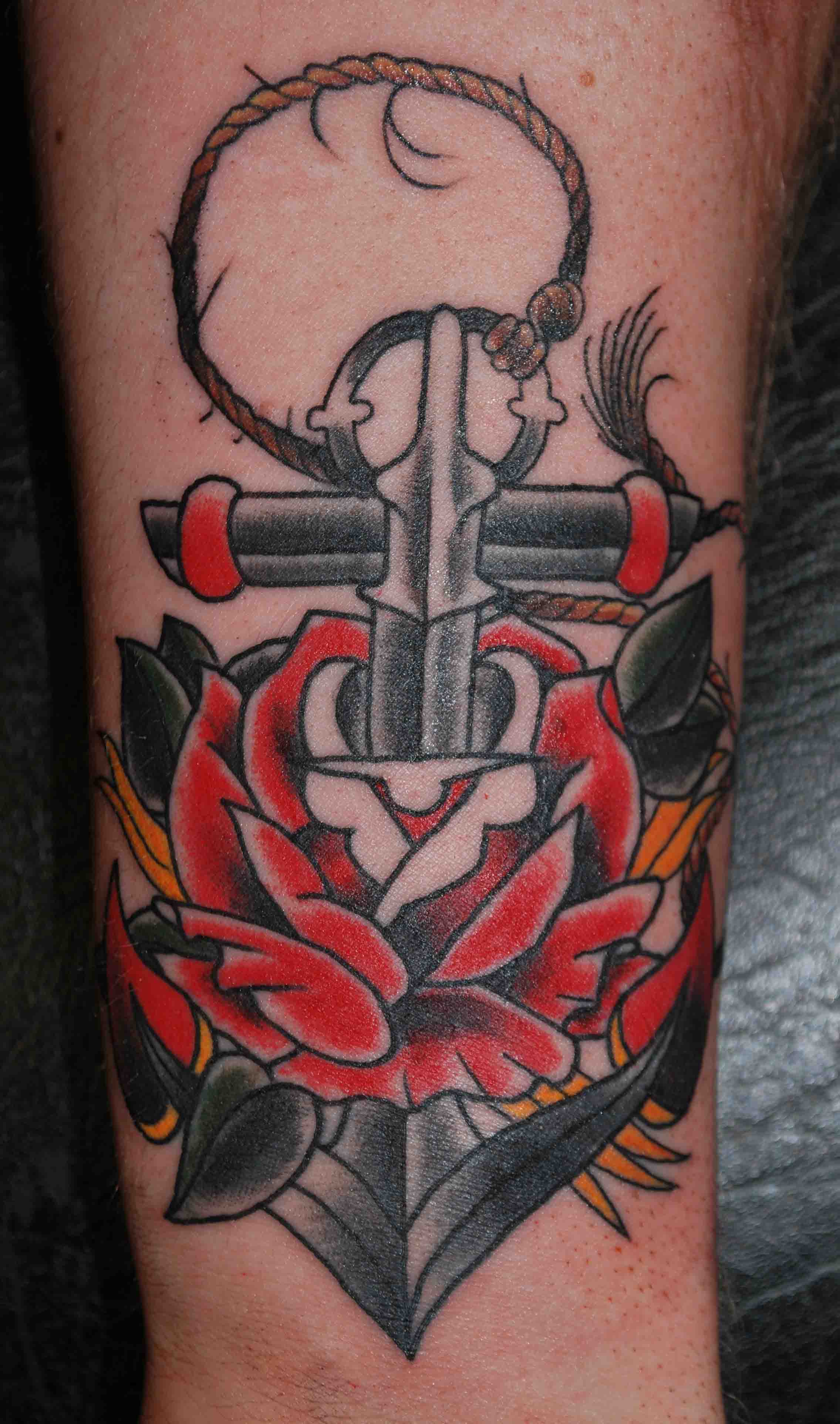 Red Rose With Black Anchor Tattoo On Arm