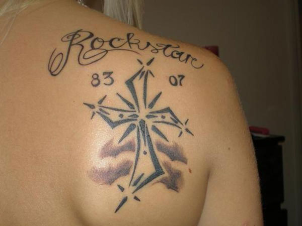 Rock-star cross tattoo on girl back shoulder