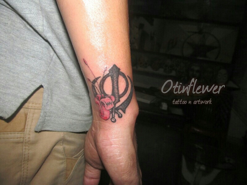 Sikhism Black Khanda With Flower Tattoo On Side Wrist By Otinflewer