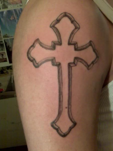 Thick grey outline cross tattoo on shoulder