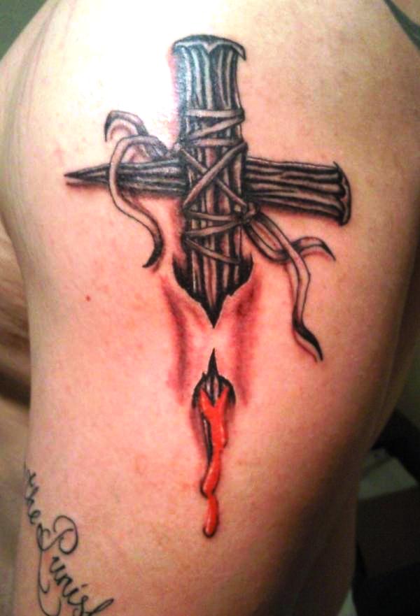 Torn skin nail cross tattoo on shoulder
