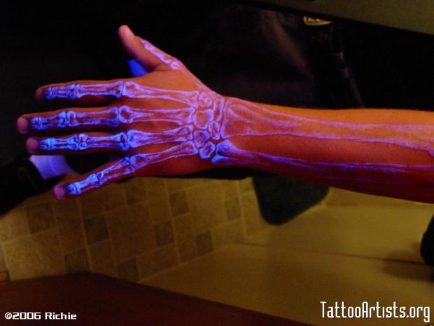 White Ink Skeleton Hand Tattoo Under Black Light