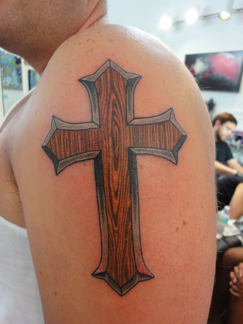 Wooden pattern cross tattoo on shoulder