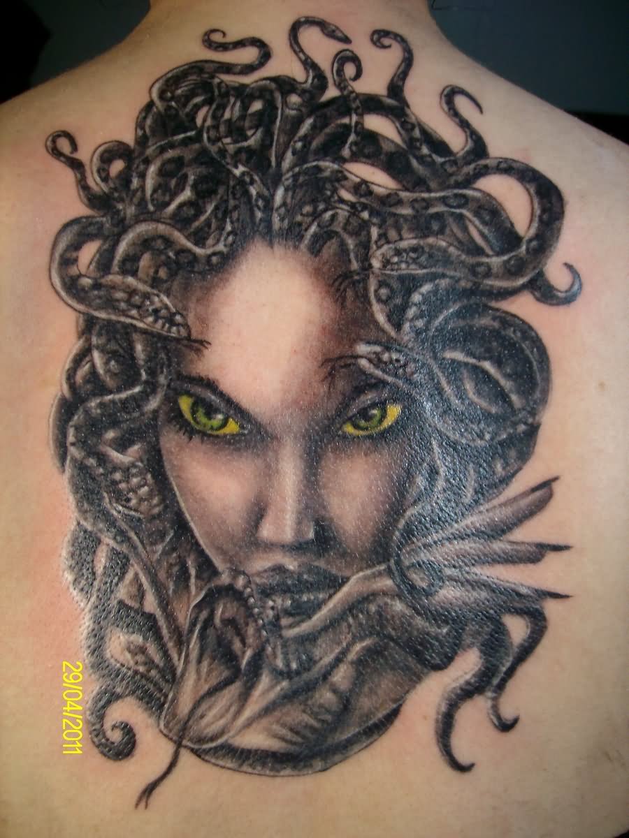 Yellow Eyes Medusa Face Tattoo On Upper Back