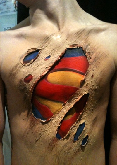 Amazing Colorful Ripped Skin Superman Logo Tattoo On Man Chest