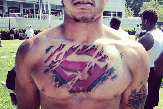 Amazing Ripped Skin Superman Logo Tattoo On Man Chest