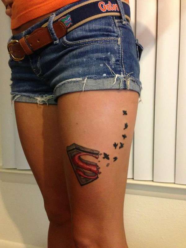 Awesome Superman Logo With Flying Birds Tattoo On Girl Thigh